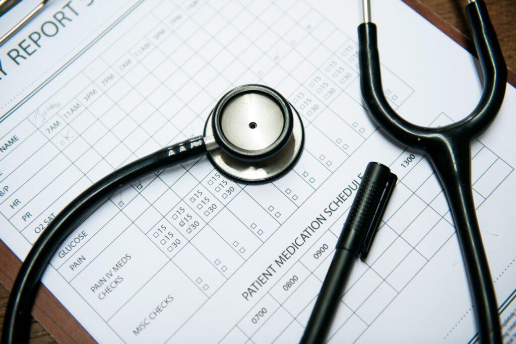 Medical report on a desk accompanied by a stethoscope, indicating a healthcare setting.