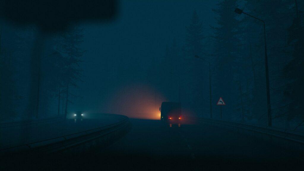 A fog-shrouded mountain road at night with a van ahead casting a warm glow through the mist, distant headlights approaching from the opposite lane, and tall dark trees and streetlamps fading into the heavy blue fog around a sharp-curve warning sign.