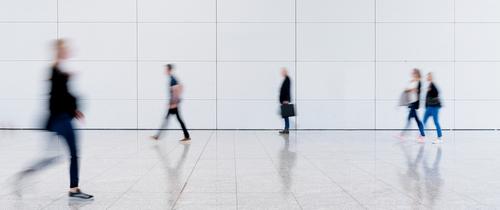 People walking through a large open hall
